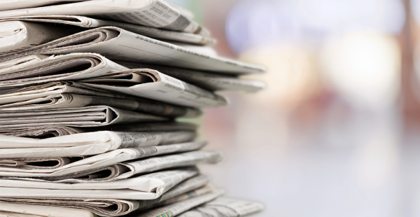 Stack of newspapers with a blurry background