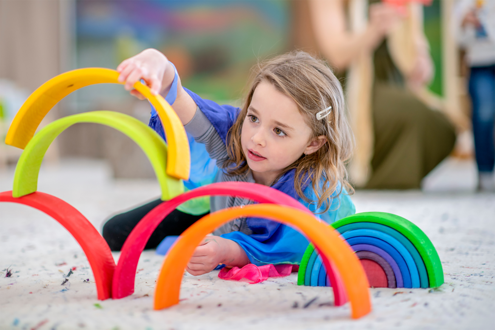 Girl Playing With Rainbow Blocks