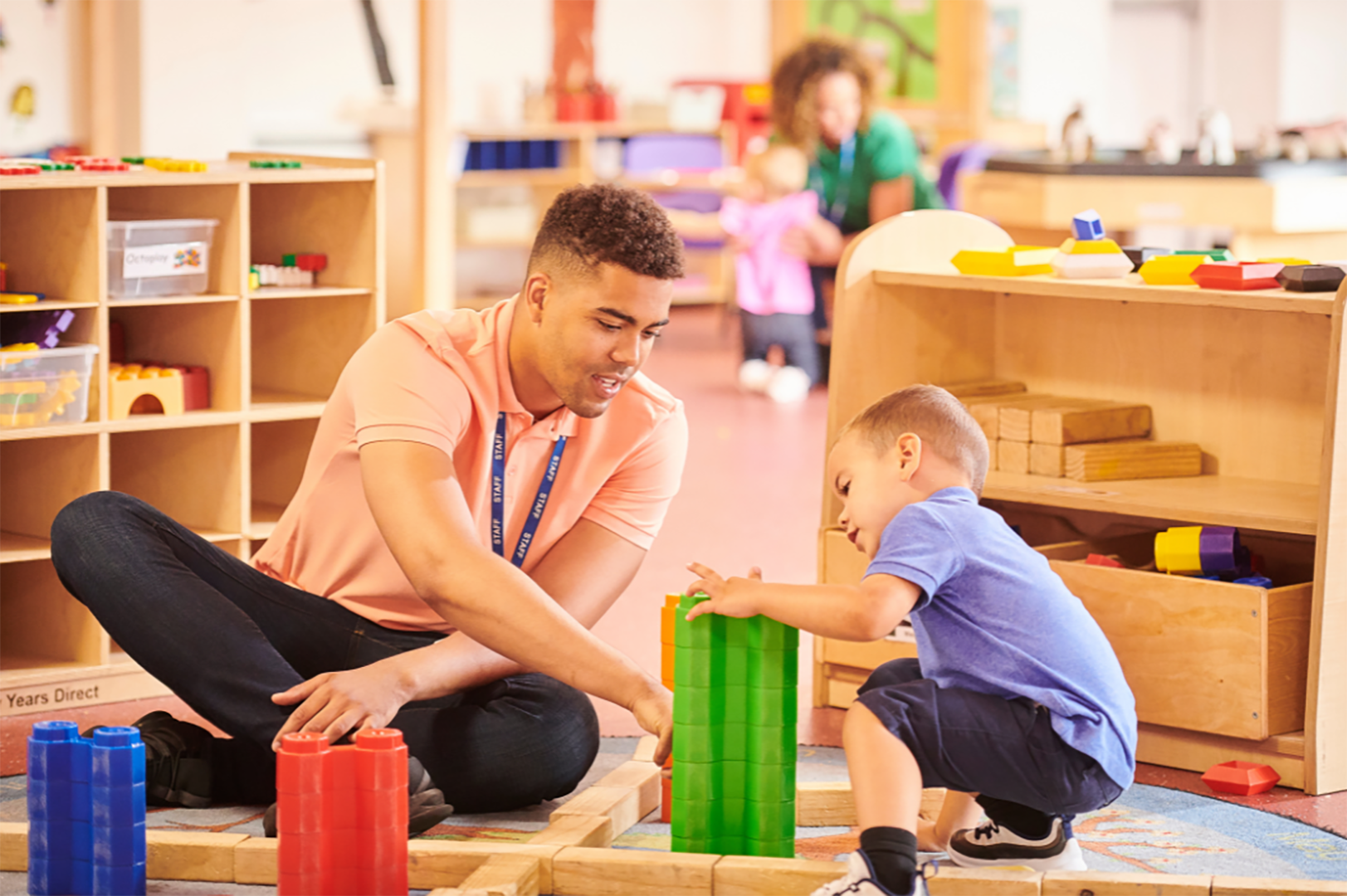 Teacher And Student Playing With Blocks