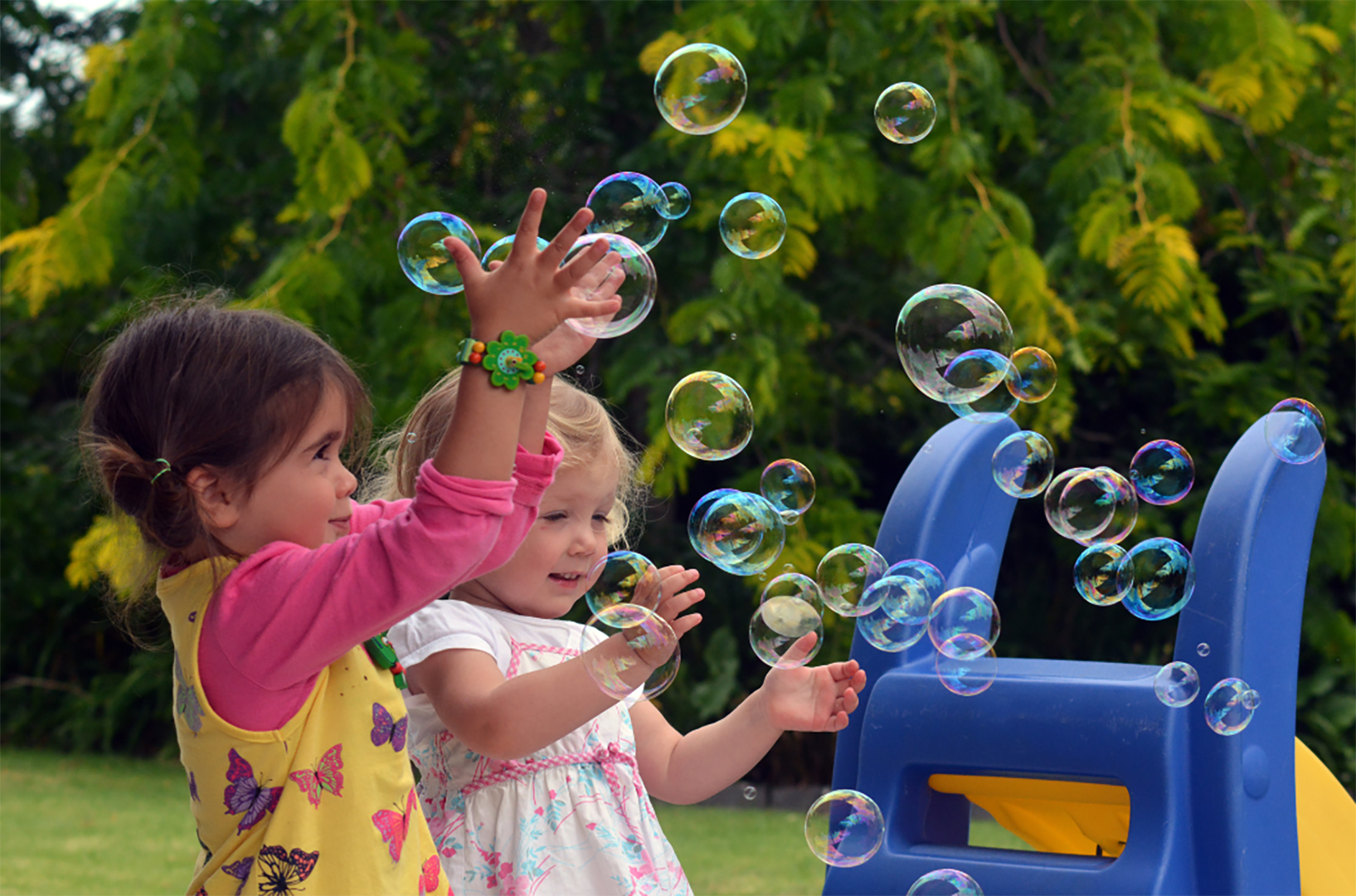 Two Girls Playing With Bubbles