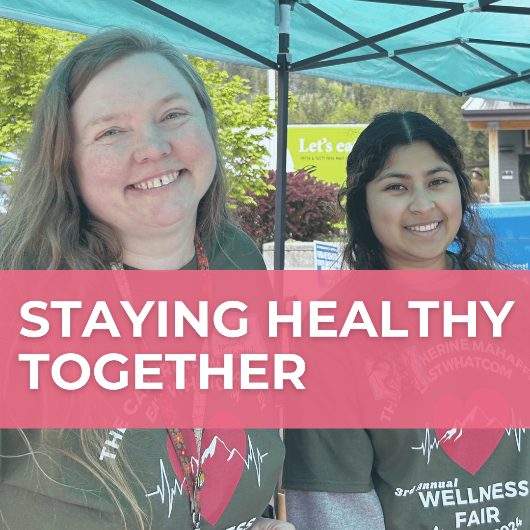 A photo of two people smiling with a pale pink banner over it that says "Staying Healthy Together" in white font.