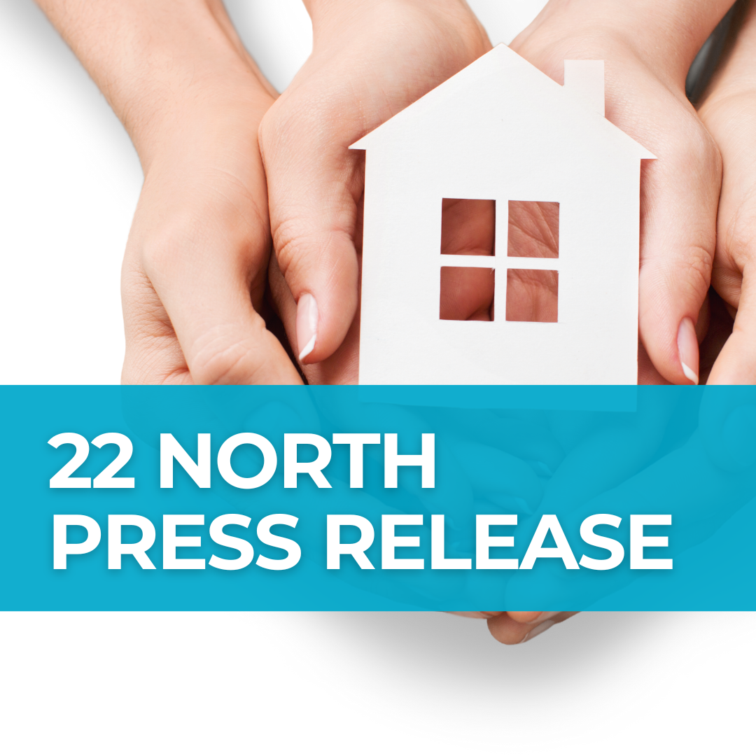 A photo of two pairs of hands holding a paper cutout of a house, with a teal banner over the photo that says "22 North Press Release"