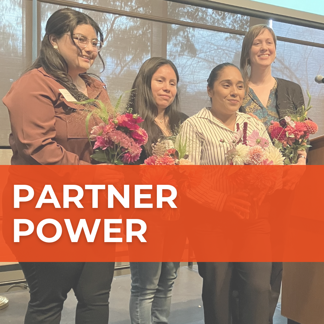 Four people hold vibrant bouquets of flowers in a photo. Over it, a red banner says "Partner Power."